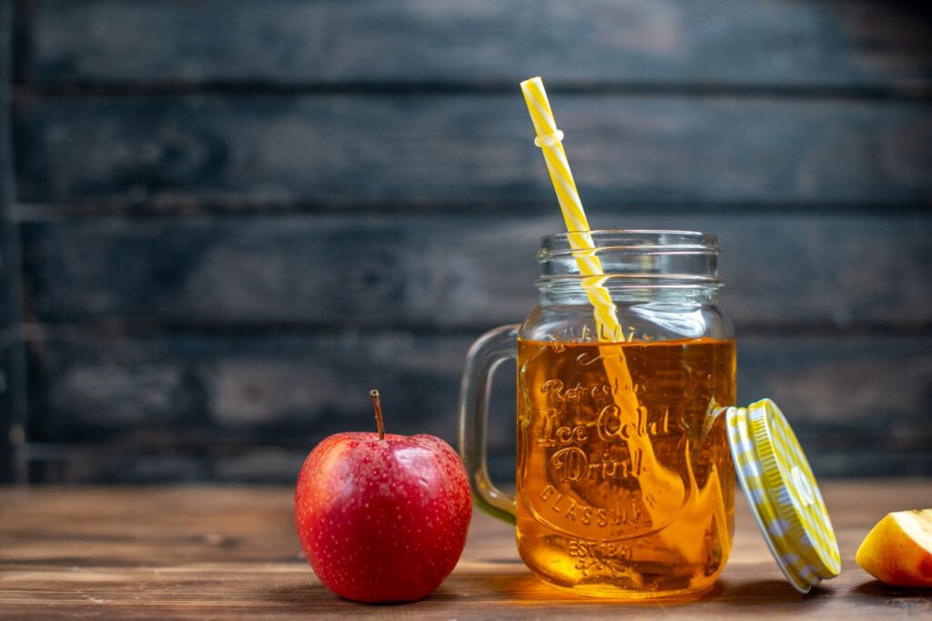 Front view fresh apple juice inside can with fresh apples on a dark bar fruit drink photo cocktail color